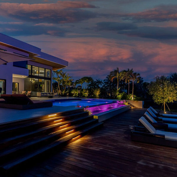 pool with chairs and lighting at night