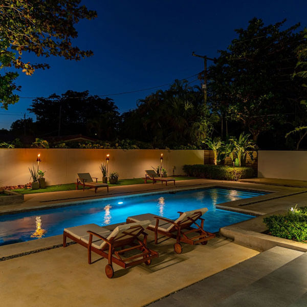 pool with chairs and lighting at night