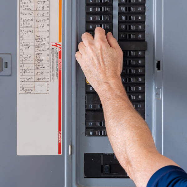 arm reaching to electrical panel