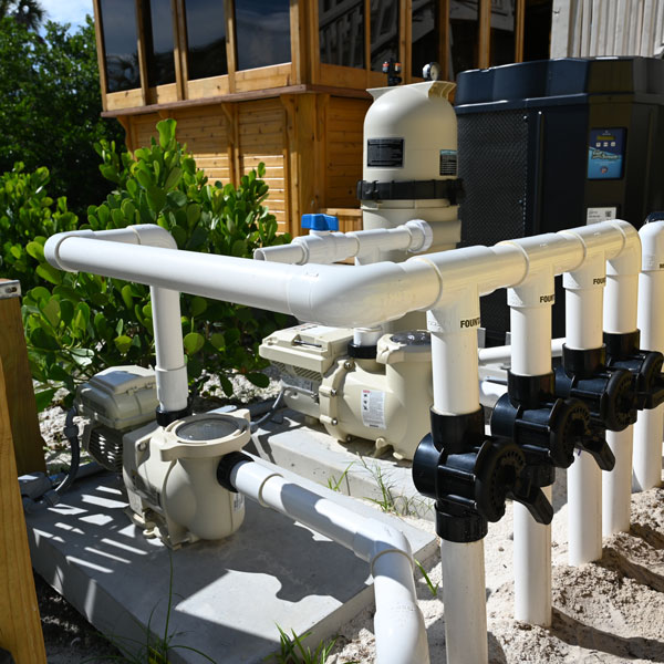 pipes and pump behind home